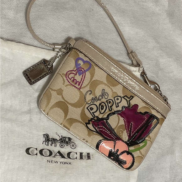 Coach Handbags - Coach Beige Signature Poppy Wristlet with Pink & Purple Floral Applique